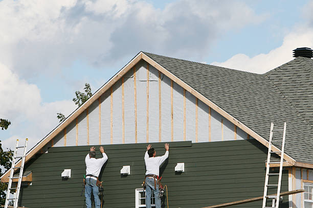 Professional Siding Installation technician working in Centerport, NY